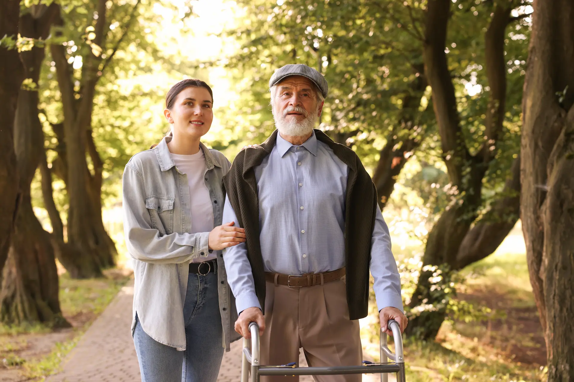 Senior man enjoying a walk in a Warwickshire park with his companion